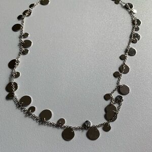 Silver tone disc necklace. Lots of light catching dangling circles.